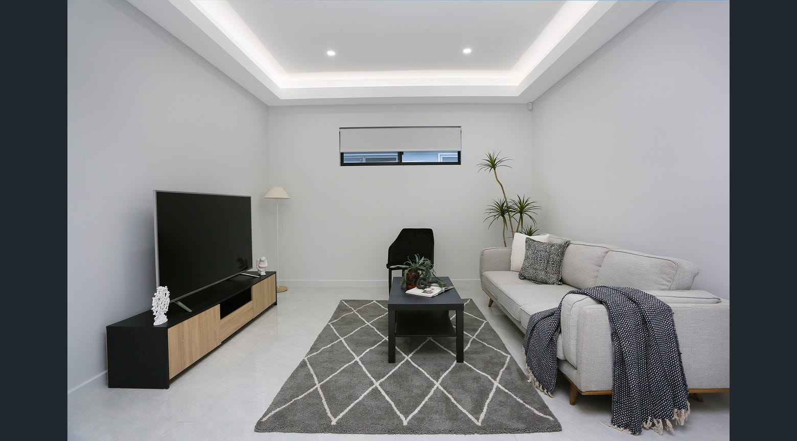 Custom TV cabinet with black and timber finish in a modern living room