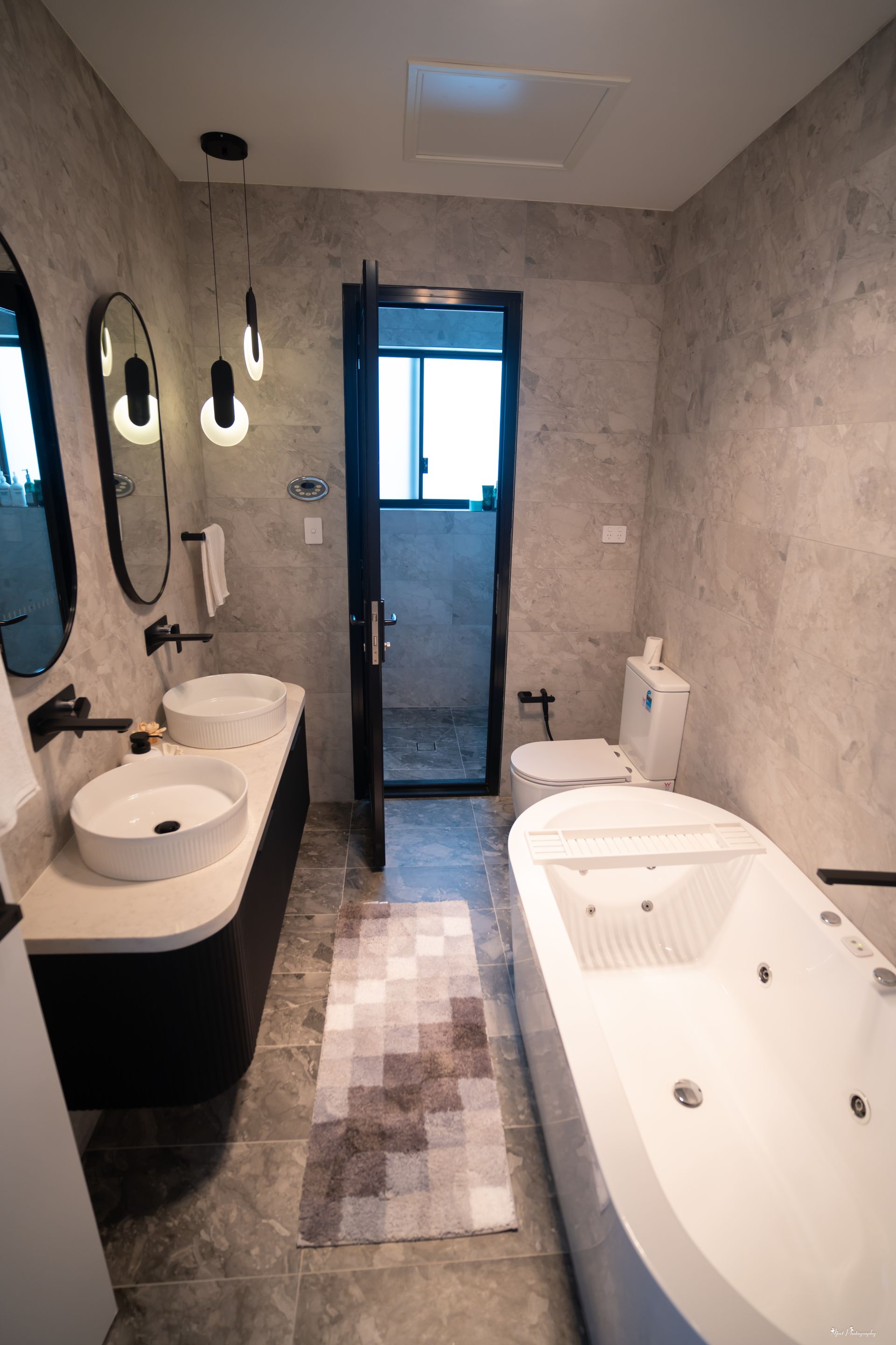 Luxury custom bathroom joinery with double vanity, freestanding bathtub and marble wall finishes
