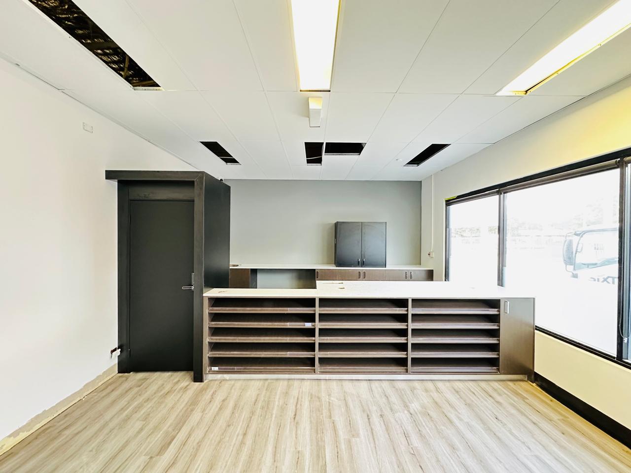 Custom commercial joinery with open shelving, cabinetry and large windows