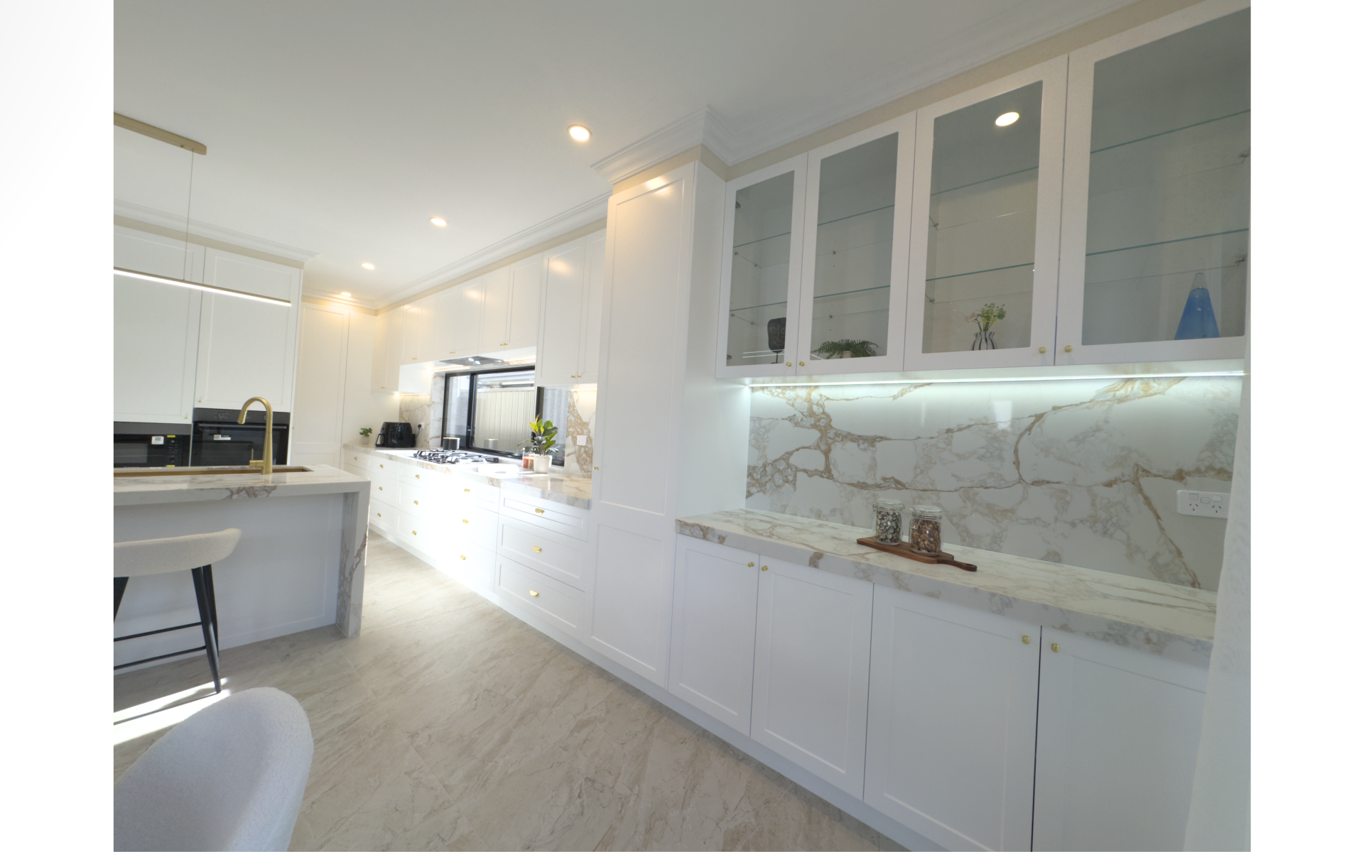 Modern kitchen with wood-grain cabinetry, white quartz surfaces, large island and decorative pendant lights