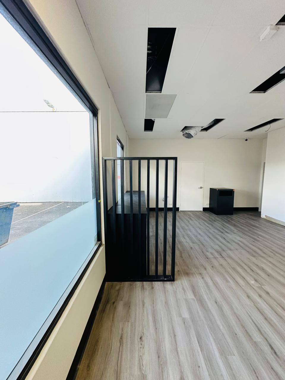 Custom black office partition and joinery in a modern commercial interior