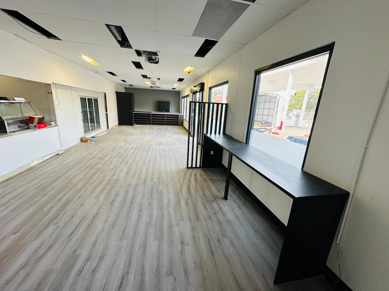 Custom black office workstations and partitions in a spacious commercial interior