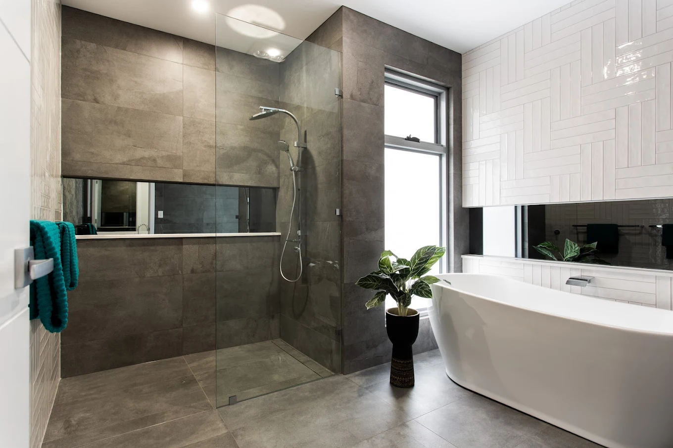 Luxury bathroom with freestanding bathtub, walk-in shower, built-in cabinetry and tiled walls