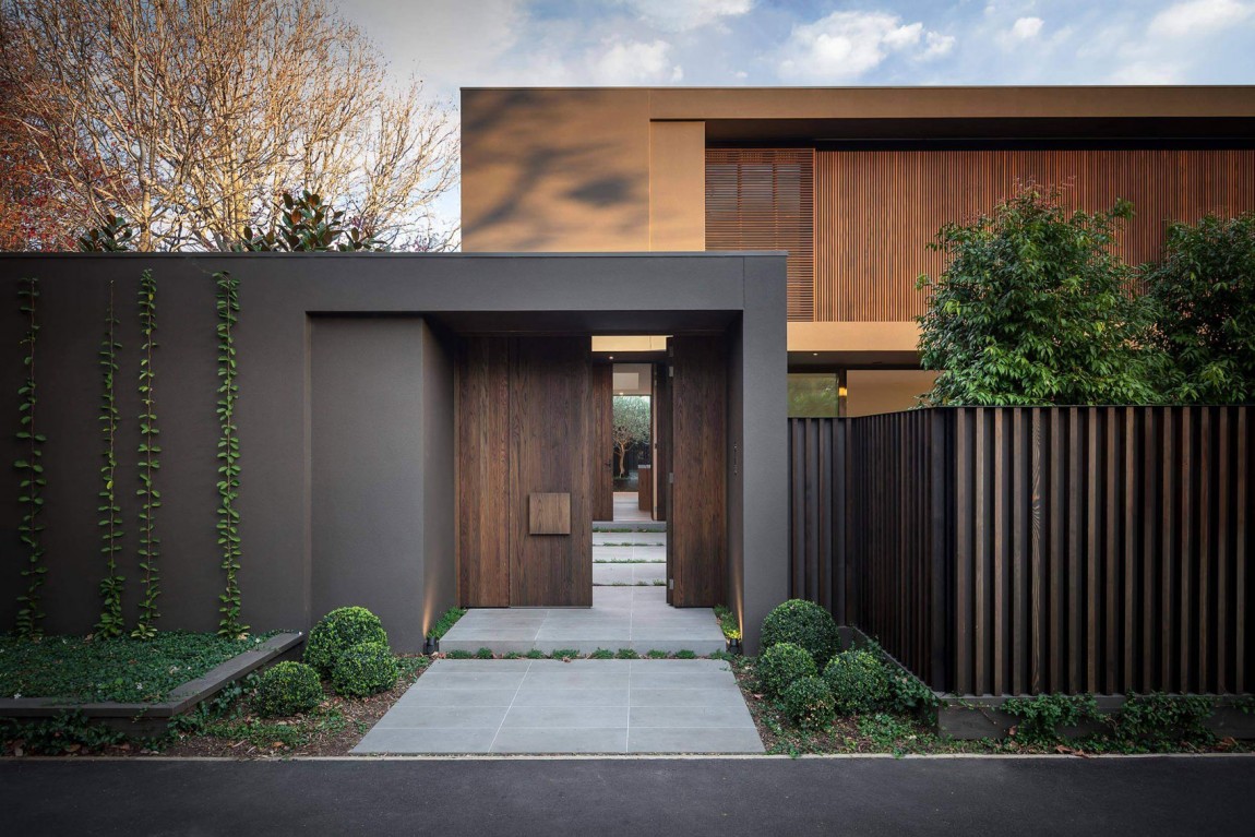 Modern home entrance with custom timber front door, vertical slatted fence and landscaped garden